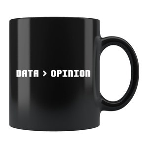 May include: Black ceramic coffee mug with white text that reads "DATA > OPINION".