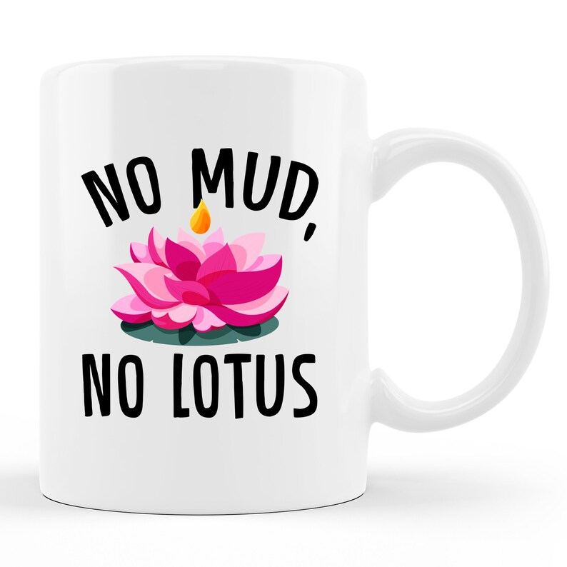 May include: White ceramic coffee mug with a pink lotus flower and the text "No mud, no lotus" in black.