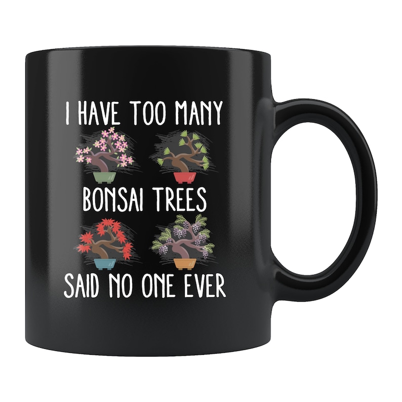 May include: Black coffee mug with white text that reads "I have too many bonsai trees said no one ever". The mug features four illustrations of bonsai trees in pots.