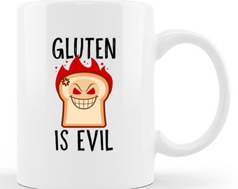 May include: White ceramic coffee mug with a black and red graphic of a slice of bread with a devilish face and the text "Gluten is Evil".