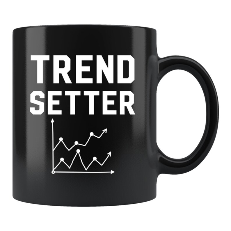 May include: Black ceramic mug with white text that reads "TREND SETTER" and a white line graph with an upward trend.