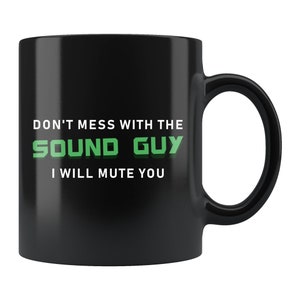 May include: Black coffee mug with white text that reads "Don't mess with the Sound Guy I will mute you". The text "Sound Guy" is in green.