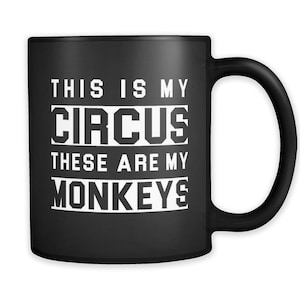 May include: Black coffee mug with white text that reads "This is my circus these are my monkeys".
