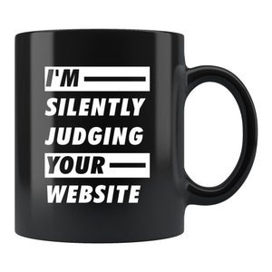 May include: Black coffee mug with white text that reads "I'm silently judging your website".