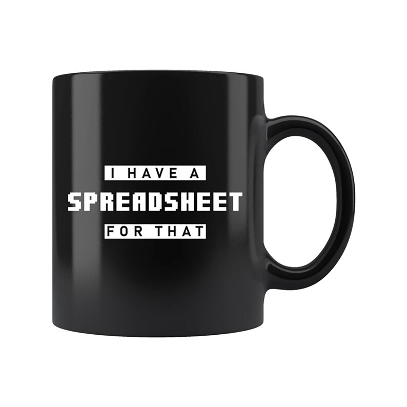 May include: Black ceramic mug with a white text that reads "I HAVE A SPREADSHEET FOR THAT". The mug has a large handle and a glossy finish. The text is in a bold, pixelated font.