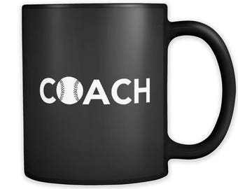 May include: Black ceramic coffee mug with a white baseball and the word "COACH" printed on it.