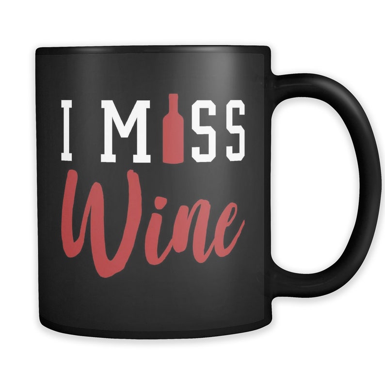 May include: Black ceramic coffee mug with a white design that says "I Miss Wine" with a red wine bottle graphic.