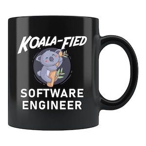 May include: Black coffee mug with a white graphic of a koala holding onto a tree branch. The text "Koala-fied Software Engineer" is printed in white on the mug.