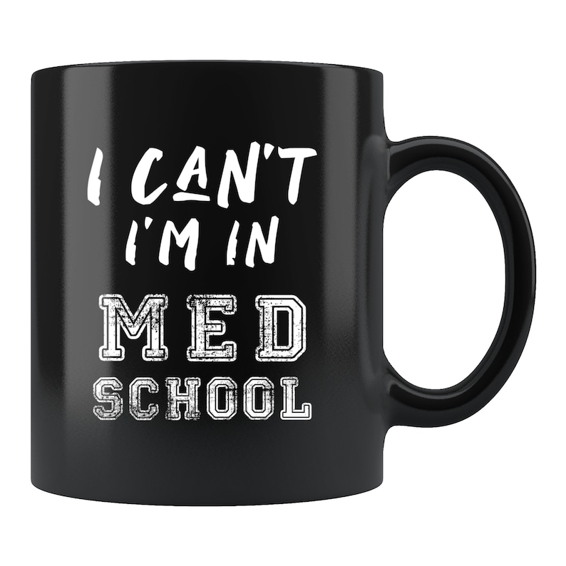 May include: Black coffee mug with white text that reads "I can't I'm in med school".