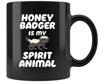 May include: Black coffee mug with white text that reads "Honey Badger is my Spirit Animal". A cartoon honey badger is pictured in the center of the mug.