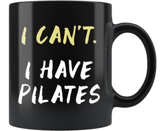May include: Black coffee mug with white text that reads "I can't. I have Pilates."