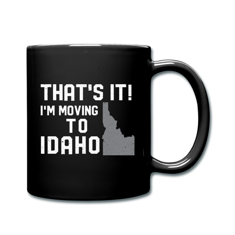 May include: Black coffee mug with white text that reads "That's it! I'm moving to Idaho" and a gray outline of the state of Idaho.