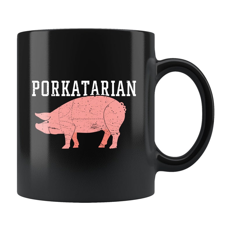 May include: Black coffee mug with a white graphic of a pig and the text "PORKATARIAN".