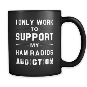 May include: Black coffee mug with white text that reads "I only work to support my ham radios addiction".