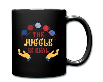 May include: Black coffee mug with a white design of juggling balls and the text "THE JUGGLE IS REAL".