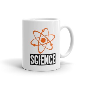 May include: White ceramic mug with a black and orange atom design and the word "SCIENCE" in black text.
