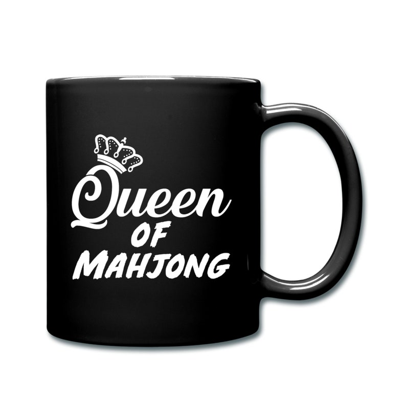 May include: Black ceramic coffee mug with a white design that says "Queen of Mahjong" with a crown above the word "Queen".