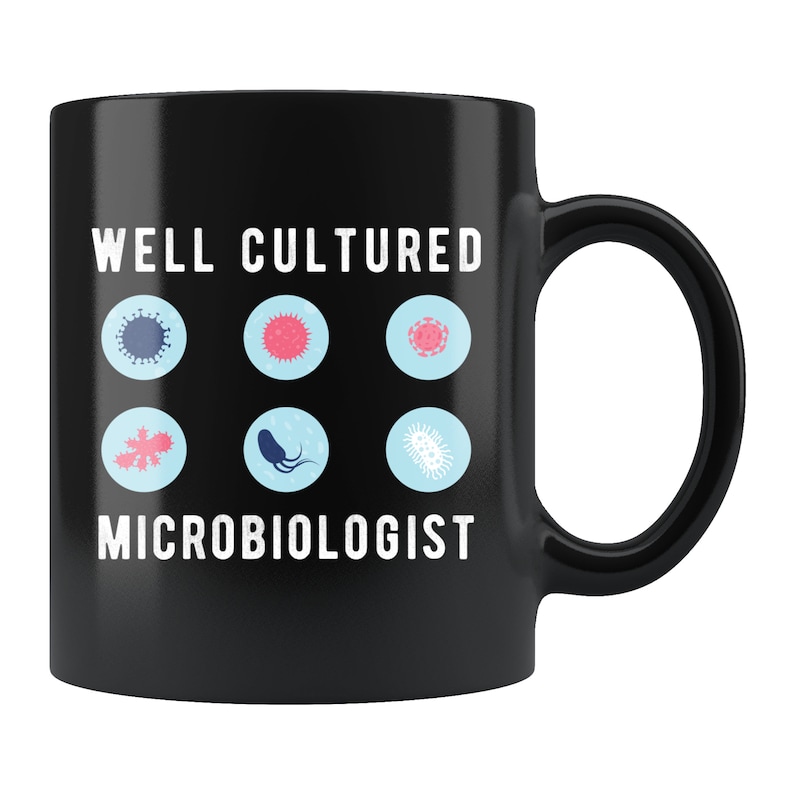 May include: Black ceramic mug with white text that reads "Well Cultured Microbiologist". The mug has a white outline of six different types of microbes.
