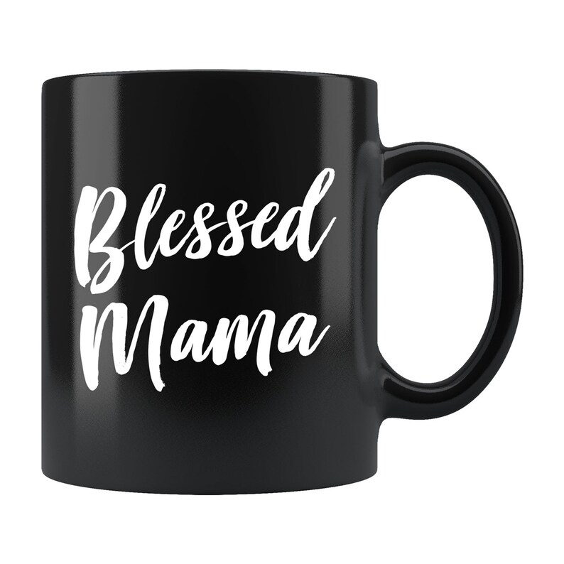 May include: Black ceramic coffee mug with white text that reads "Blessed Mama".