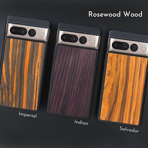 May include: Three phone cases with rosewood wood backs. The cases have black frames and silver camera housings. The wood grains are labeled "Imperial", "Indian", and "Salvador", with colors ranging from orange and brown to deep reddish-brown.