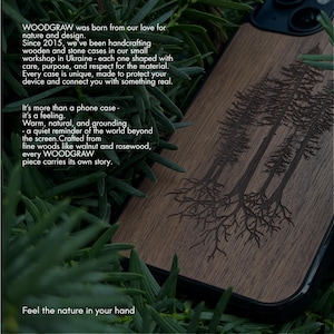 May include: A wooden phone case with a dark brown finish, featuring an engraved design of several trees. The case is surrounded by green foliage. The text on the case reads "WOODGRAW" and "Feel the nature in your hand."