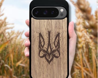 May include: A black smartphone case featuring a light brown wood grain back panel. The center of the wood panel displays a dark brown, stylized Ukrainian Tryzub emblem with a distressed, speckled texture throughout the design.