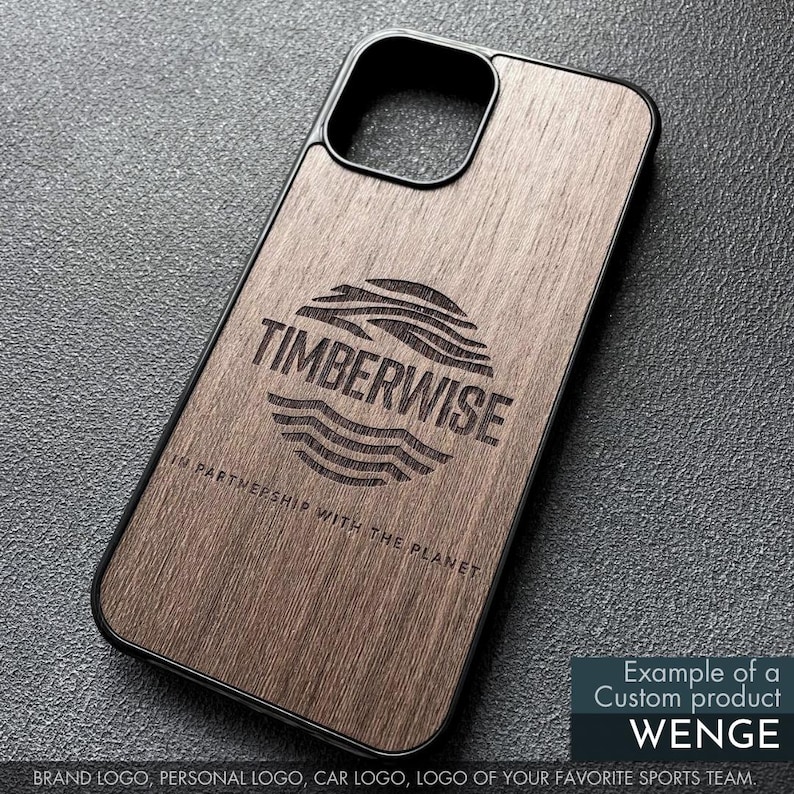 May include: A wooden phone case with a black border. The case features the Timberwise logo and the text "IN PARTNERSHIP WITH THE PLANET." The case is an example of a custom product, Wenge, and can feature a brand logo, personal logo, car logo, or sports team logo.