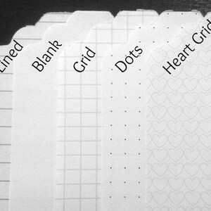 May include: A collection of white paper tags with different patterns. The tags are labeled "Lined", "Blank", "Grid", "Dots", and "Heart Grid". The lined tag has horizontal lines, the grid tag has a square pattern, the dots tag has evenly spaced dots, and the heart grid tag has a heart pattern.