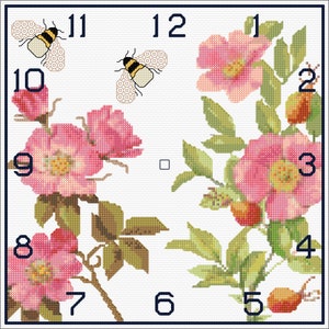 Puede incluir: Una esfera de reloj cuadrada con rosas rosas y hojas verdes. La esfera del reloj tiene números romanos y dos abejas con rayas negras y amarillas.