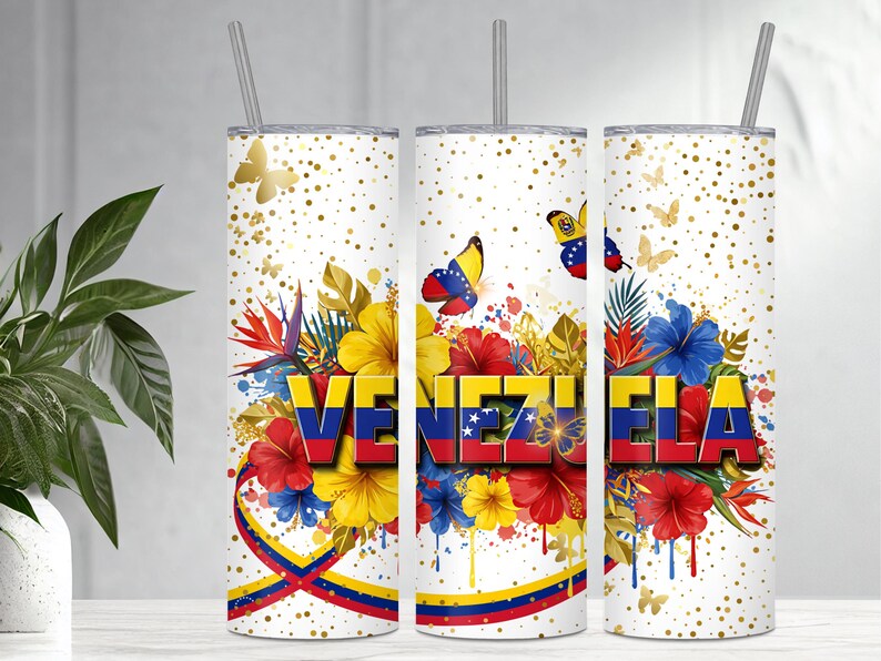 May include: A white tumbler with a design featuring the word "VENEZUELA" in red, yellow, and blue, surrounded by colorful flowers and butterflies. The design includes the Venezuelan flag colors and gold accents.