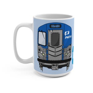 May include: White ceramic mug featuring a blue illustration of a PATH train car. The train car has the text "33rd St" and the PATH logo. The mug has a light blue background.