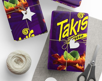 May include: Gift-wrapped boxes with purple Takis-themed paper, tied with twine and adorned with white tags. The design features the Takis logo, flames, and lime slices. A ball of twine, scissors, and blank tags are also present.