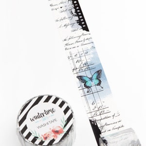 May include: A roll of black and white striped washi tape with a floral design and the text "wintertime crafts washi tape". The tape features a blue butterfly and a watercolor background with handwritten text and numbers.