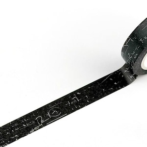 May include: A roll of black washi tape featuring a repeating pattern of white mathematical equations, scientific formulas, and various symbols printed across the surface. The tape is partially unrolled, displaying the detailed white text and graphics.