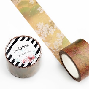 May include: Two rolls of washi tape. One roll has a black and white striped background with the text "wintertime washi tape" and a floral design. The other roll has a brown background with a floral design.