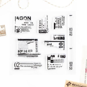 May include: A set of vintage-style rubber stamps featuring various text and designs, including "Jagon", "Spring", "Comedie", "This Co.", "Nov 14 1911", "Jun 6 1980", and "03 40".