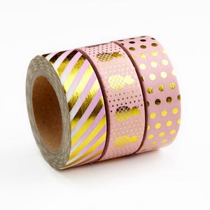May include: Three rolls of pink and gold washi tape. The tape has different patterns, including stripes, polka dots, and pineapples.