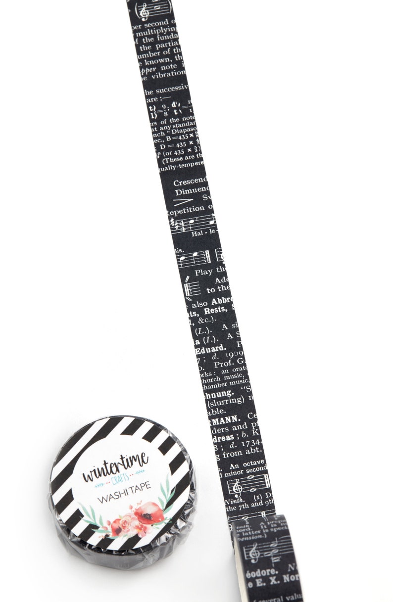 Washi tape with details from a vintage music dictionary. Black background.