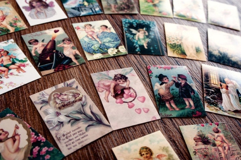 May include: A collection of vintage-style cards featuring cherubs, angels, and other romantic imagery. The cards are printed on thick paper and have a distressed, antique look. They are perfect for scrapbooking, card making, or adding a touch of vintage charm to any project.