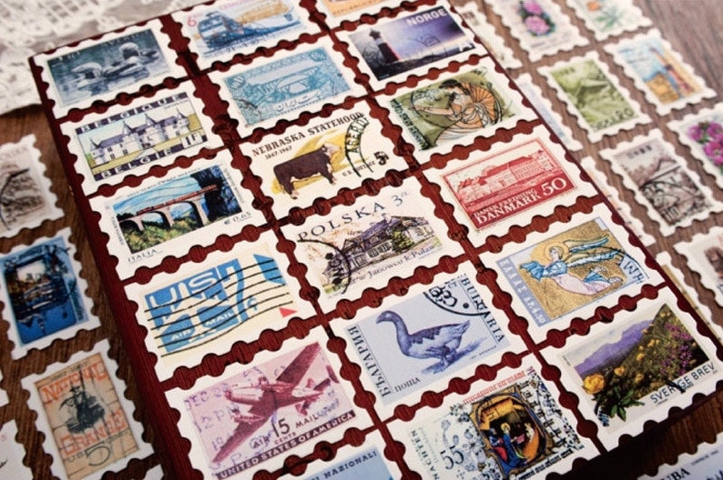 May include: A collection of vintage postage stamps from around the world, featuring images of a lighthouse, a cow, a building, a bridge, an airplane, a goose, a woman, an angel, and a flower. The stamps are arranged in a grid pattern on a red background.