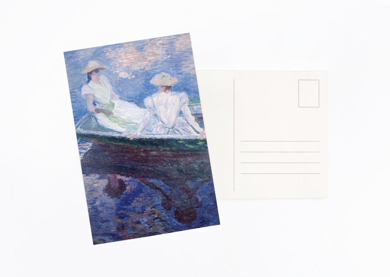 May include: A postcard with an impressionist painting of two people in a boat on a lake. The artwork shows figures in white dresses and hats, with reflections in the water. The back of the postcard is blank with lines for writing.