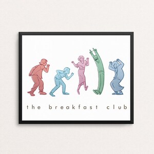 May include: A framed art print with a line drawing of five figures in different poses, each in a different colour. The words "the breakfast club" are printed in black below the figures. The background is white.