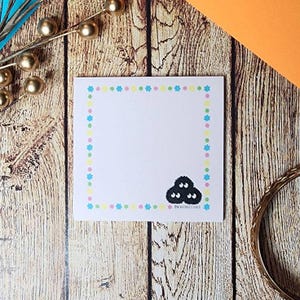 Pink sticky note with soot sprite with konpeito candy border inspired by Studio Ghibli.