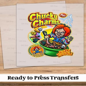 May include: A ready-to-press transfer featuring a cartoon illustration of Chucky from the Child's Play franchise. Chucky is holding a spoon and bowl of cereal with the words "Chucky Charms" and "They're Magically Malicious!"  The transfer also includes a smaller image of a cartoon character with the words "Free Good Guy Inside!"