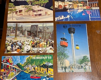 May include: Five vintage postcards featuring images from the 1968 HemisFair '68 World's Fair in San Antonio, Texas. The postcards show various attractions, including the iconic Tower of the Americas, the  'The  Institute of Texan Cultures' building, and a view of the river.