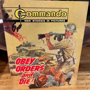 May include: A vintage comic book cover featuring a soldier with a gun standing on a tank. The cover is yellowed and has the title "Commando" and the text "Obey Orders and Die!" in red.