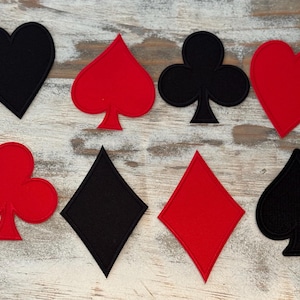 May include: Eight felt patches in the shapes of playing card suits: black heart, red spade, black club, red heart, black diamond, red diamond, black spade, and red club.