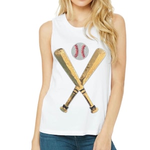 May include: White sleeveless shirt with a gold sequin baseball bat and ball design.