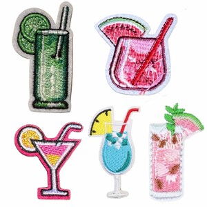 May include: A set of five embroidered patches featuring colorful cocktail designs. The collection includes a green drink with lime, a pink drink with watermelon, a pink martini with orange, a blue drink with pineapple, and a pink drink with mint.