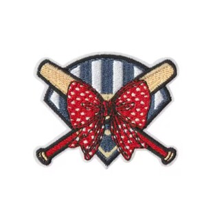 May include: Embroidered patch featuring a baseball theme. The design includes two crossed baseball bats with tan handles and red accents, a red bow with white polka dots, and a blue and white striped baseball shape.